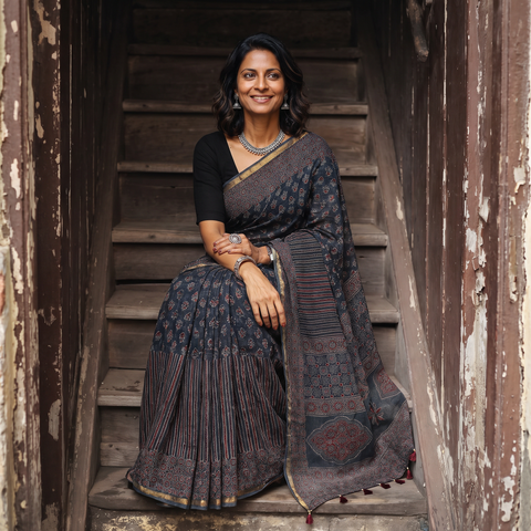 Black Kutch Ajrakh hand block print natural dyed Kota Doria cotton saree, draped and worn by a woman, AI visual of the saree, iTokri