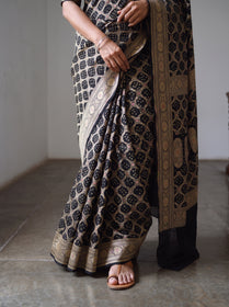 Black Kutch Bandhani Fine Georgette Banarasi Neem Zari Jaal Saree, draped and worn by a woman, AI visual of the saree, iTokri