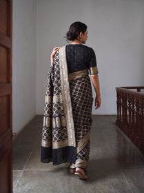 Black Kutch Bandhani Fine Georgette Banarasi Neem Zari Jaal Saree, draped and worn by a woman, AI visual of the saree, iTokri
