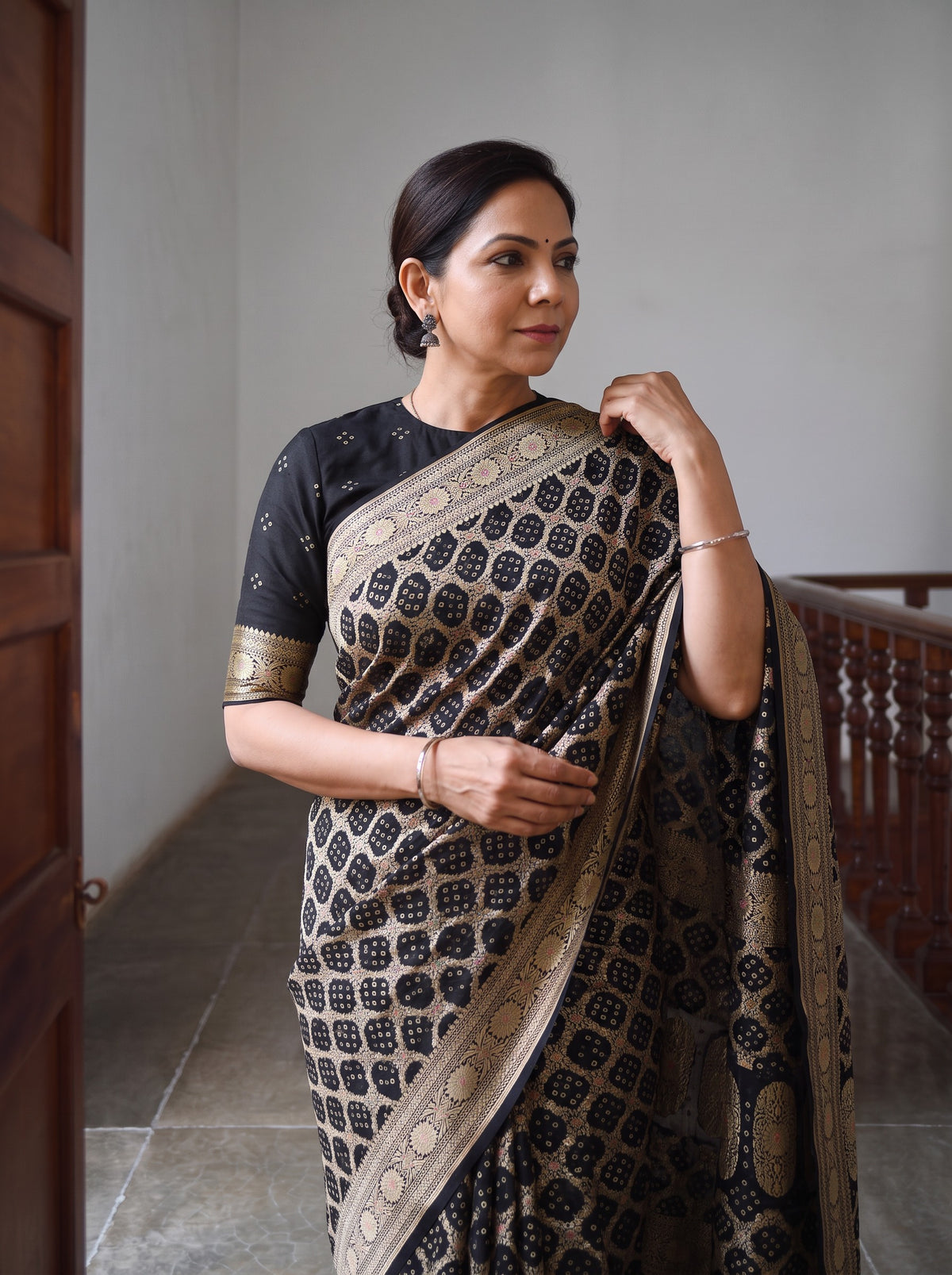 Black Kutch Bandhani Fine Georgette Banarasi Neem Zari Jaal Saree, draped and worn by a woman, AI visual of the saree, iTokri