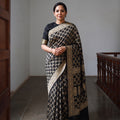 Black Kutch Bandhani Fine Georgette Banarasi Neem Zari Jaal Saree, draped and worn by a woman, AI visual of the saree, iTokri