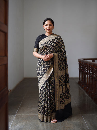 Black Kutch Bandhani Fine Georgette Banarasi Neem Zari Jaal Saree, draped and worn by a woman, AI visual of the saree, iTokri
