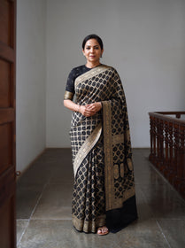 Black Kutch Bandhani Fine Georgette Banarasi Neem Zari Jaal Saree, draped and worn by a woman, AI visual of the saree, iTokri