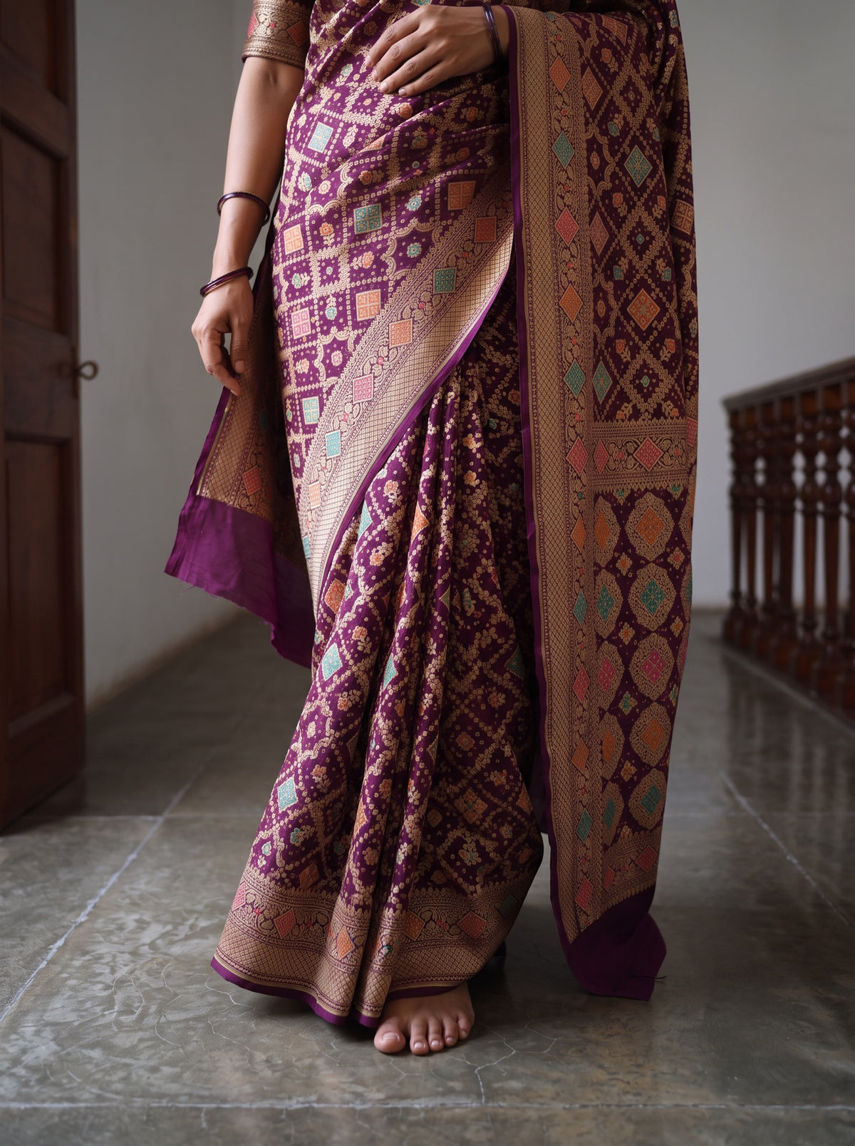 Maroon Kutch Bandhani Fine Georgette Banarasi Neem Zari Jaal Saree, draped and worn by a woman, AI visual of the saree, iTokri