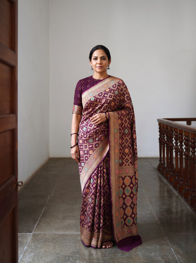Maroon Kutch Bandhani Fine Georgette Banarasi Neem Zari Jaal Saree, draped and worn by a woman, AI visual of the saree, iTokri