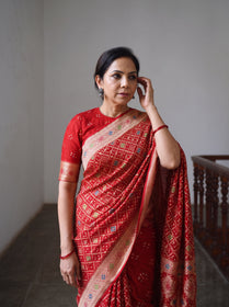 Red Kutch Bandhani Fine Georgette Banarasi Neem Zari Jaal Saree, draped and worn by a woman, AI visual of the saree, iTokri