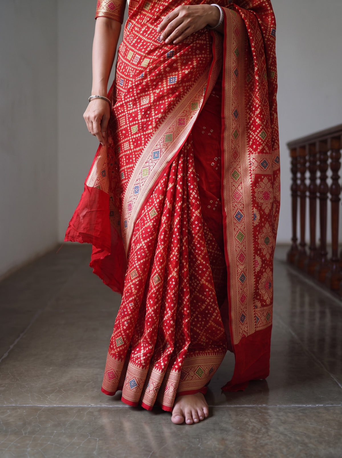 Red Kutch Bandhani Fine Georgette Banarasi Neem Zari Jaal Saree, draped and worn by a woman, AI visual of the saree, iTokri