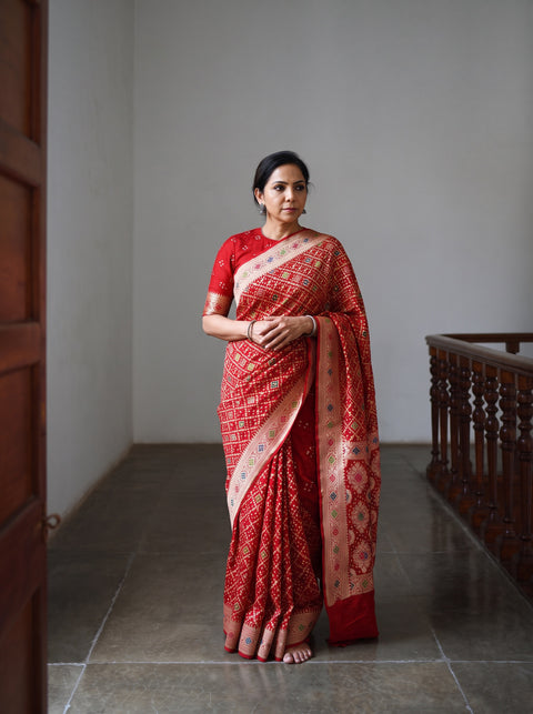 Red Kutch Bandhani Fine Georgette Banarasi Neem Zari Jaal Saree, draped and worn by a woman, AI visual of the saree, iTokri