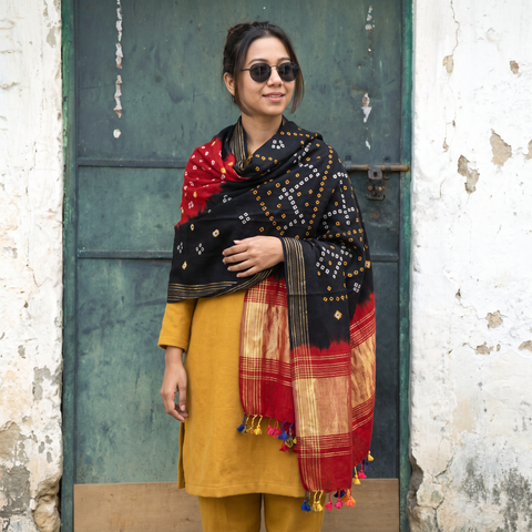 Black Kutch Bandhani Handwoven Merino Wool Shawl with Zari Patta, worn by a model, AI visual of the shawl, iTokri