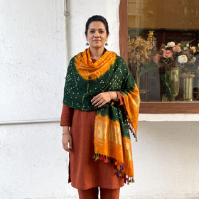 Green Kutch Bandhani Handwoven Merino Wool Shawl with Zari Patta, worn by a model, AI visual of the shawl, iTokri