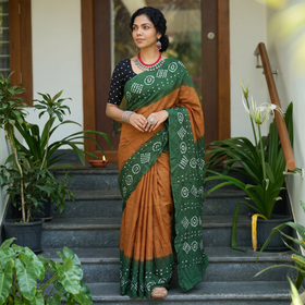 Green and brown Kutch Bandhani tie-dye cotton saree, draped and worn by a woman, AI visual of the saree, iTokri
