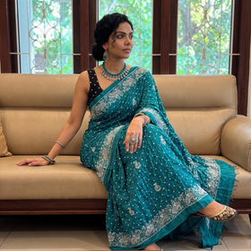 Green Kutch Bandhani tie-dye cotton saree, draped and worn by a woman, AI visual of the saree, iTokri