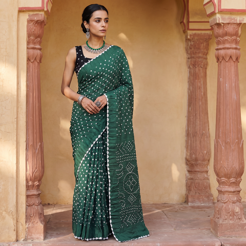 Green Kutch Bandhani tie-dye cotton saree, draped and worn by a woman, AI visual of the saree, iTokri