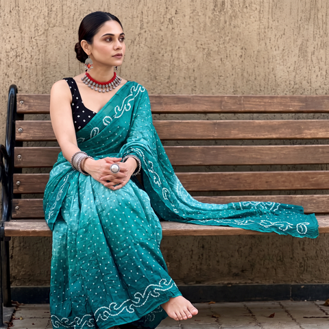Green Kutch Bandhani tie-dye cotton saree, draped and worn by a woman, AI visual of the saree, iTokri