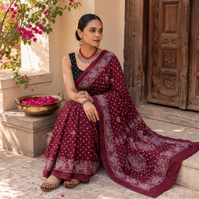 Maroon Kutch Bandhani tie-dye cotton saree, draped and worn by a woman, AI visual of the saree, iTokri