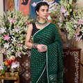 Green Kutch Bandhani tie-dye cotton saree, draped and worn by a woman, AI visual of the saree, iTokri