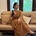 Yellow Kutch Bandhani tie-dye cotton saree, draped and worn by a woman, AI visual of the saree, iTokri