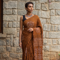 Brown Kutch Bandhani tie-dye cotton saree, draped and worn by a woman, AI visual of the saree, iTokri