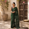 Green Kutch Bandhani tie-dye cotton saree, draped and worn by a woman, AI visual of the saree, iTokri