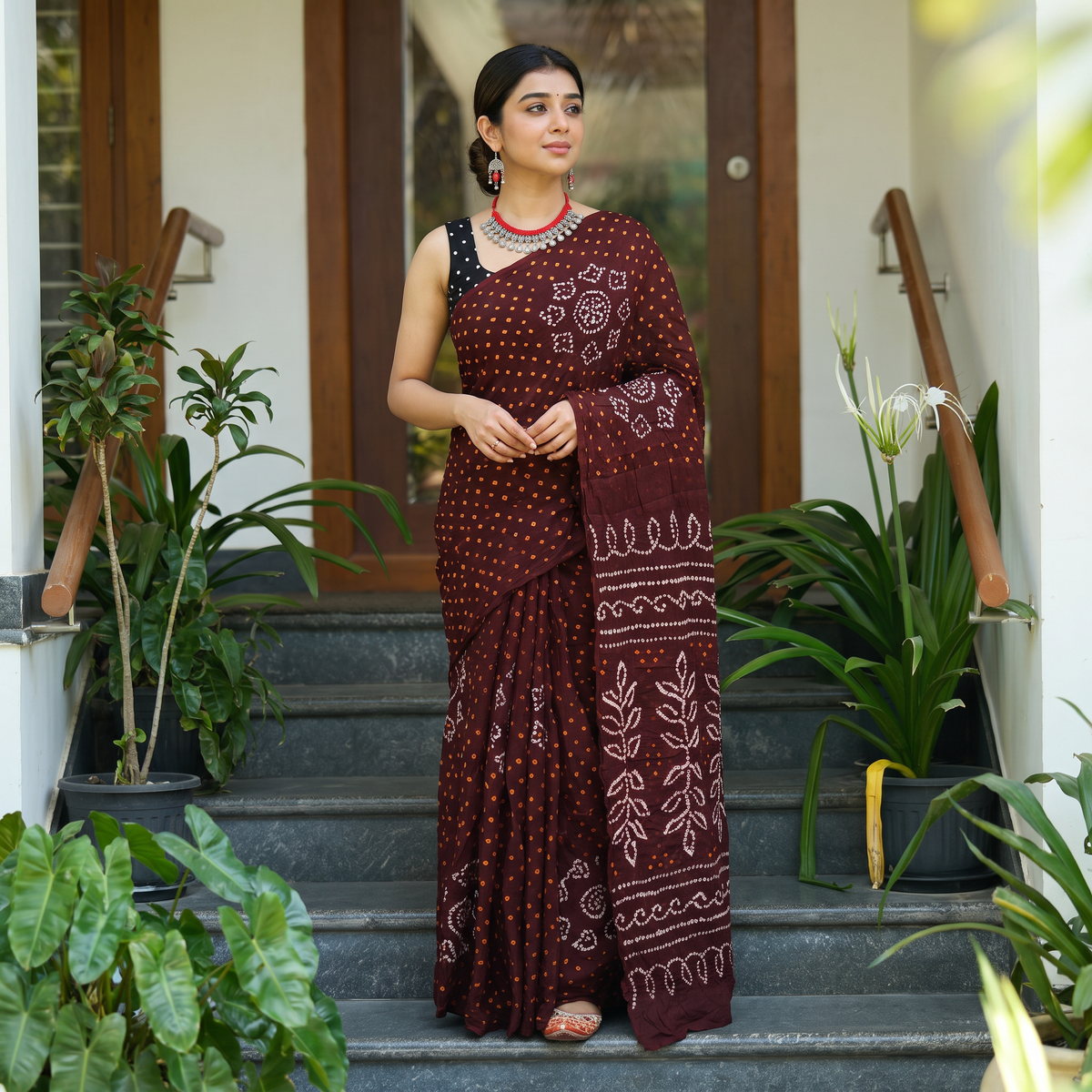 Maroon Kutch Bandhani tie-dye cotton saree, draped and worn by a woman, AI visual of the saree, iTokri