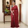 Red Kutch Bandhani tie-dye cotton saree, draped and worn by a woman, AI visual of the saree, iTokri
