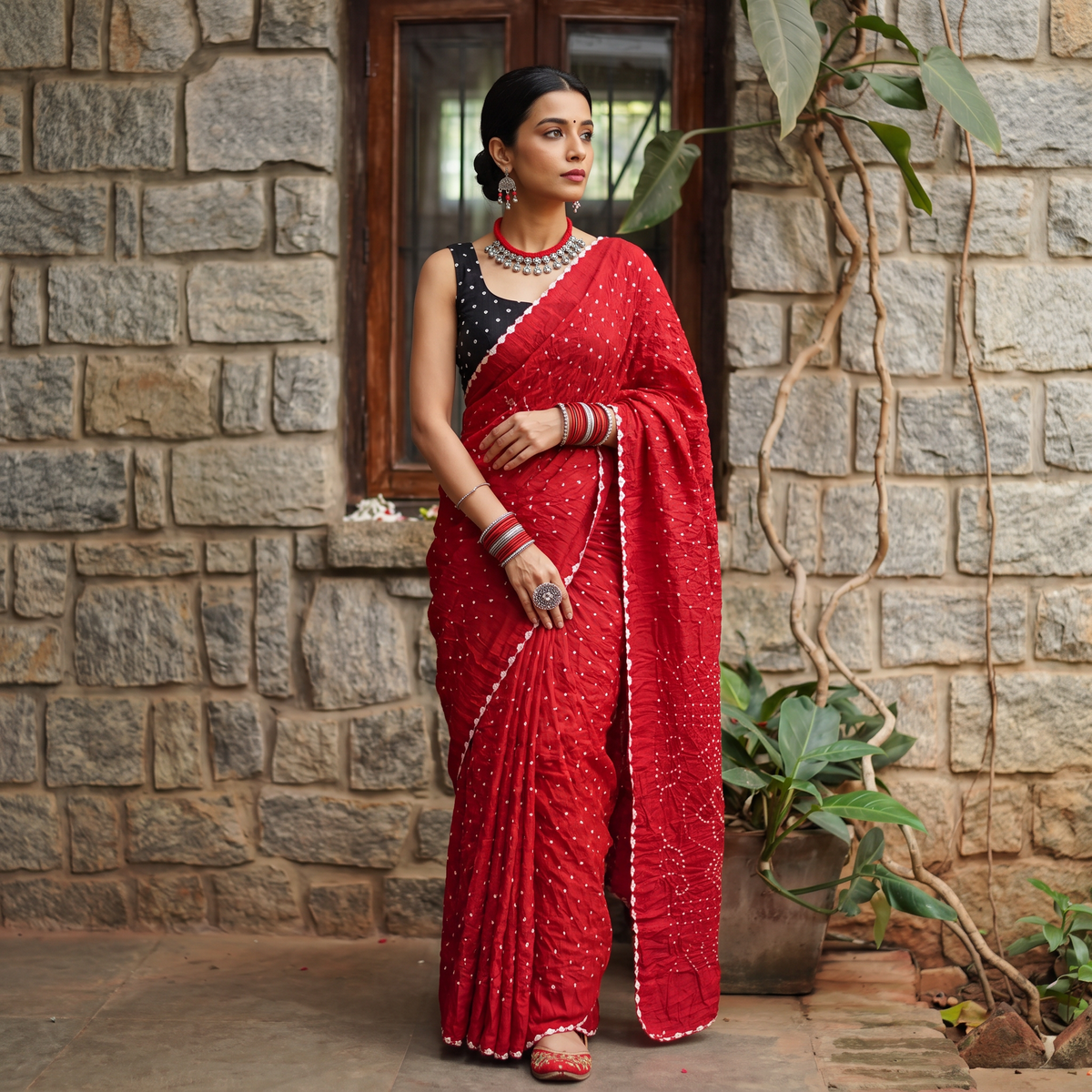 Red Kutch Bandhani tie-dye cotton saree, draped and worn by a woman, AI visual of the saree, iTokri