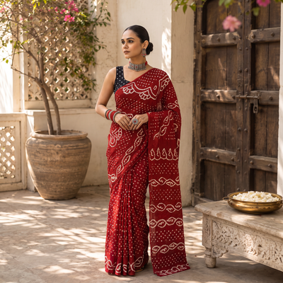 Red Kutch Bandhani tie-dye cotton saree, draped and worn by a woman, AI visual of the saree, iTokri