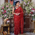 Red Kutch Bandhani tie-dye cotton saree, draped and worn by a woman, AI visual of the saree, iTokri