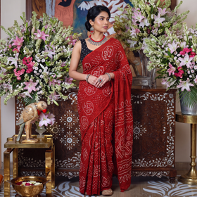 Red Kutch Bandhani tie-dye cotton saree, draped and worn by a woman, AI visual of the saree, iTokri