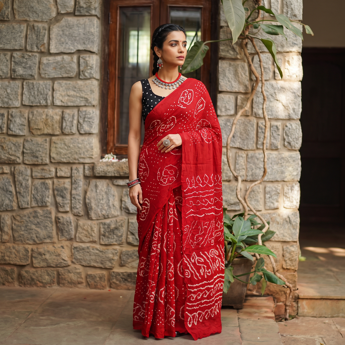Red Kutch Bandhani tie-dye cotton saree, draped and worn by a woman, AI visual of the saree, iTokri