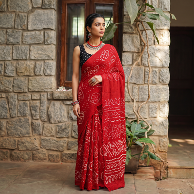 Red Kutch Bandhani tie-dye cotton saree, draped and worn by a woman, AI visual of the saree, iTokri