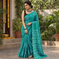 Green Kutch Bandhani tie-dye cotton saree, draped and worn by a woman, AI visual of the saree, iTokri