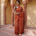 Orange Kutch Bandhani tie-dye cotton saree, draped and worn by a woman, AI visual of the saree, iTokri