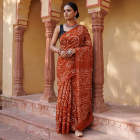 Orange Kutch Bandhani tie-dye cotton saree, draped and worn by a woman, AI visual of the saree, iTokri