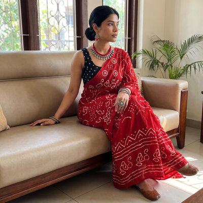 Red Kutch Bandhani tie-dye cotton saree, draped and worn by a woman, AI visual of the saree, iTokri