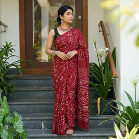 Red Kutch Bandhani tie-dye cotton saree, draped and worn by a woman, AI visual of the saree, iTokri
