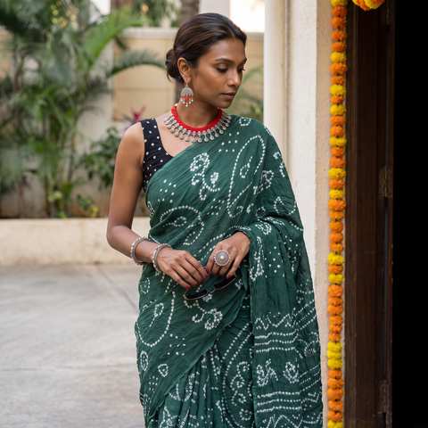 Green Kutch Bandhani tie-dye cotton saree, draped and worn by a woman, AI visual of the saree, iTokri