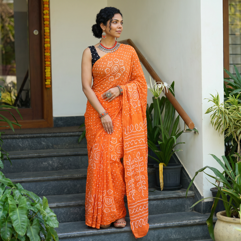 Orange Kutch Bandhani tie-dye cotton saree, draped and worn by a woman, AI visual of the saree, iTokri