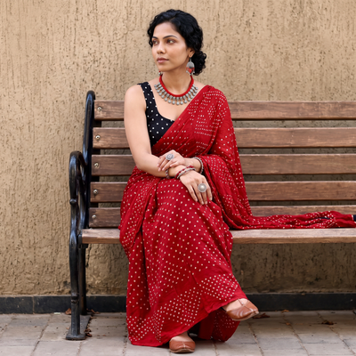 Red Kutch Bandhani tie-dye cotton saree, draped and worn by a woman, AI visual of the saree, iTokri