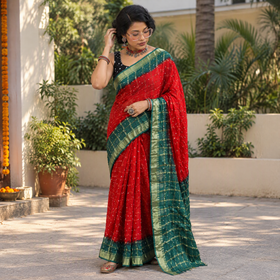 Red Kutch Bandhani tie-dye cotton saree, draped and worn by a woman, AI visual of the saree, iTokri