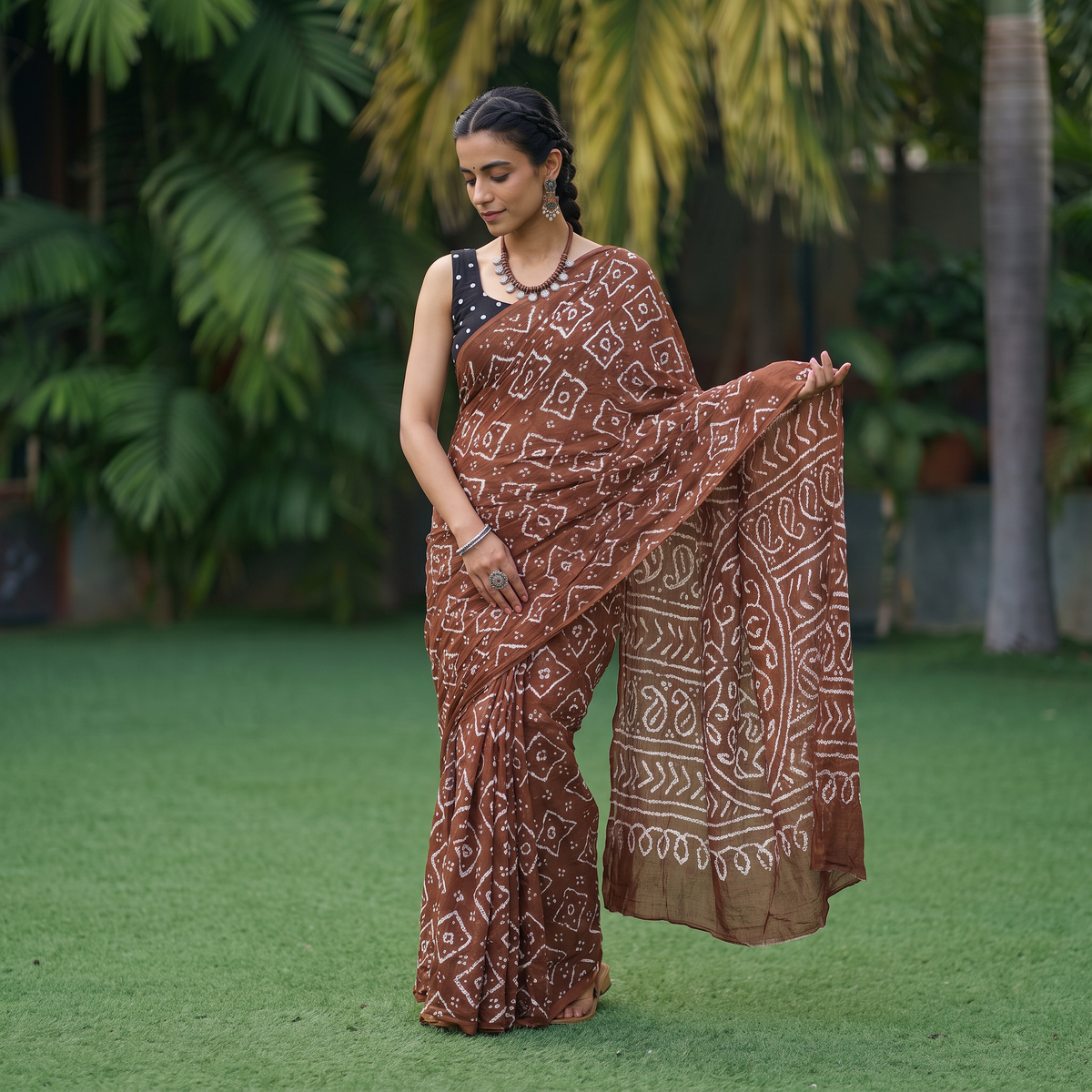 Brown Kutch Bandhani tie-dye cotton saree, draped and worn by a woman, AI visual of the saree, iTokri