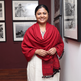 Red Kutch Bhujodi Handwoven Merino Wool Shawl, worn by a model, AI visual of the shawl, iTokri