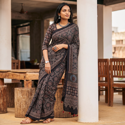 Black Kutch Hand Block Print Natural Dyed Pure Mul Cotton Ajrakh Saree with Tassels, draped and worn by a woman, AI visual of the saree, iTokri