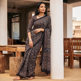 Black Kutch Hand Block Print Natural Dyed Pure Mul Cotton Ajrakh Saree with Tassels, draped and worn by a woman, AI visual of the saree, iTokri