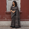 Black Kutch Hand Block Print Natural Dyed Pure Mul Cotton Ajrakh Saree with Tassels, draped and worn by a woman, AI visual of the saree, iTokri