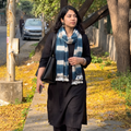 Blue Kutch Handwoven Clamp Dyed Merino Wool x Katia Silk Shibori Stole, worn by a woman, AI visual of the stole, iTokri