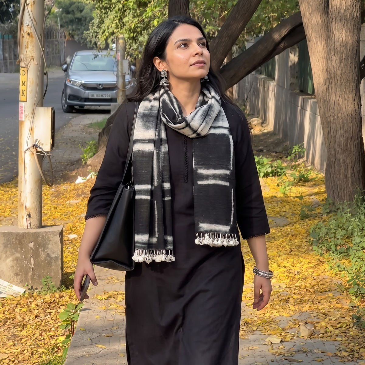 Black Kutch Handwoven Clamp Dyed Merino Wool x Katia Silk Shibori Stole, worn by a woman, AI visual of the stole, iTokri
