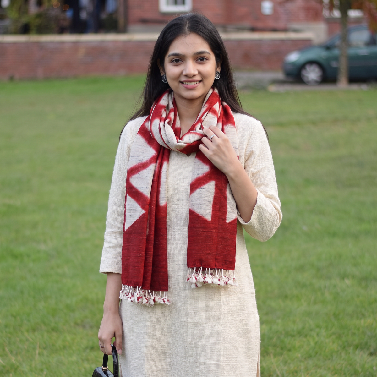 Red Kutch Handwoven Clamp Dyed Merino Wool x Katia Silk Shibori Stole, worn by a woman, AI visual of the stole, iTokri