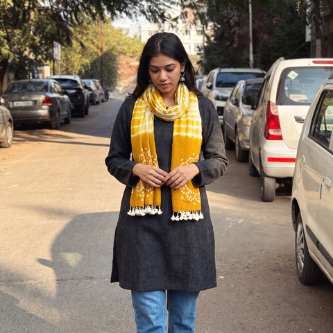Yellow Kutch Handwoven Merino Wool Shibori & Bandhani Stole, worn by a woman, AI visual of the stole, iTokri