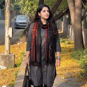 Black Kutch Handwoven Merino Woolen Shibori & Bandhani Stole, worn by a woman, AI visual of the stole, iTokri